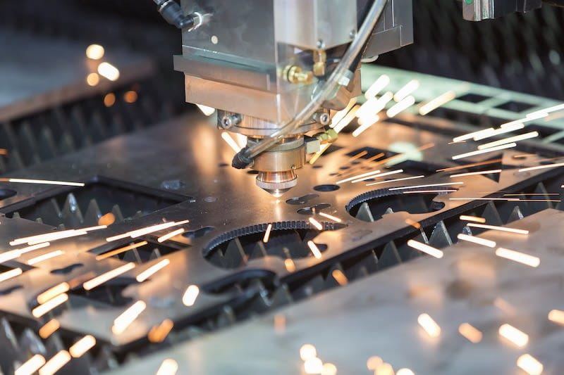 Laser cutting of sheet metal in progress